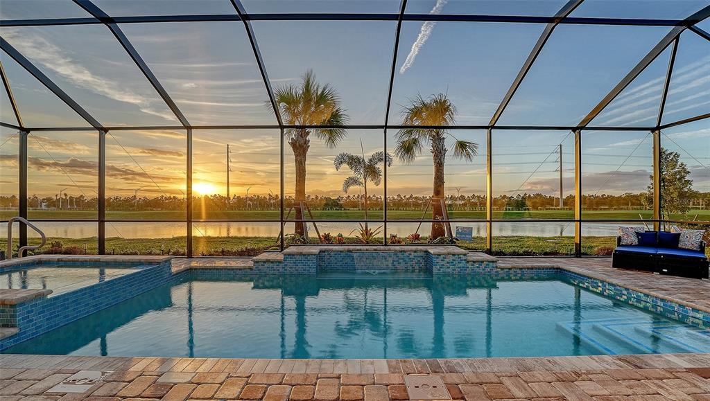 5612 Lightning Whelk Lane Lakewood Ranch, FL 34211 - Photo 16 of 44 a living room with couches and pool view