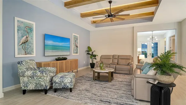 a living room with furniture and a dining table with wooden floor