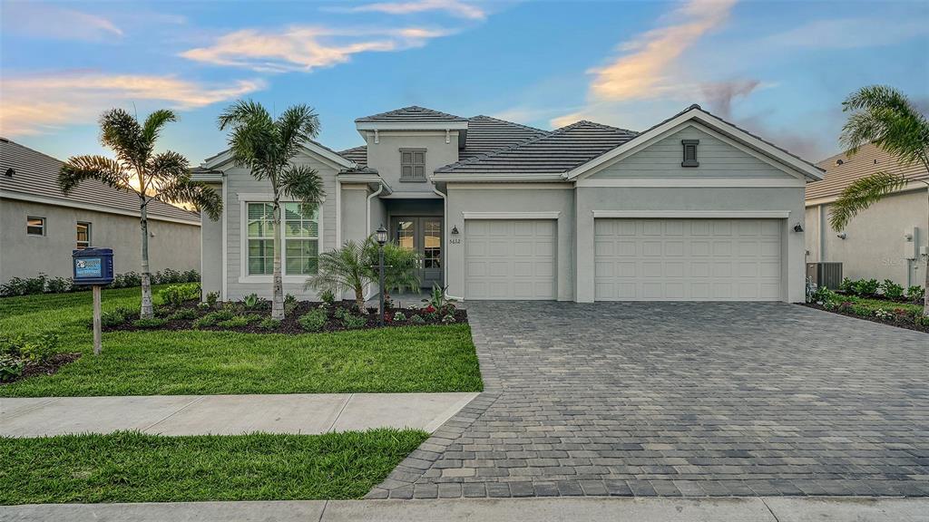 5612 Lightning Whelk Lane Lakewood Ranch, FL 34211 - Photo 2 of 44 a front view of house with yard and green space