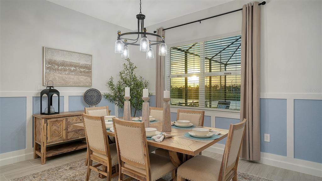 5612 Lightning Whelk Lane Lakewood Ranch, FL 34211 - Photo 21 of 44 a dining room with furniture a chandelier and window