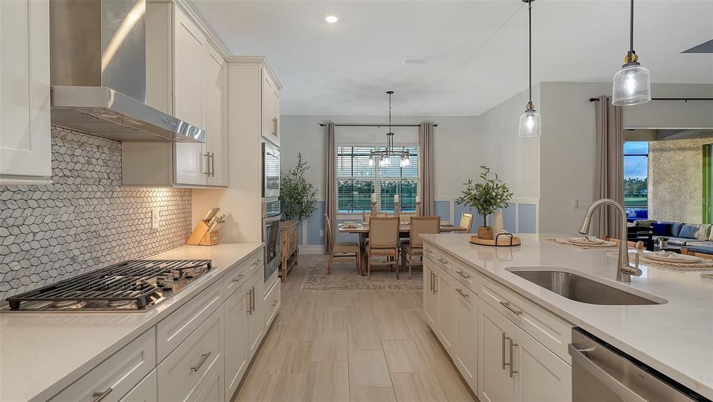 5612 Lightning Whelk Lane Lakewood Ranch, FL 34211 - Photo 23 of 44 a kitchen with sink stove and refrigerator