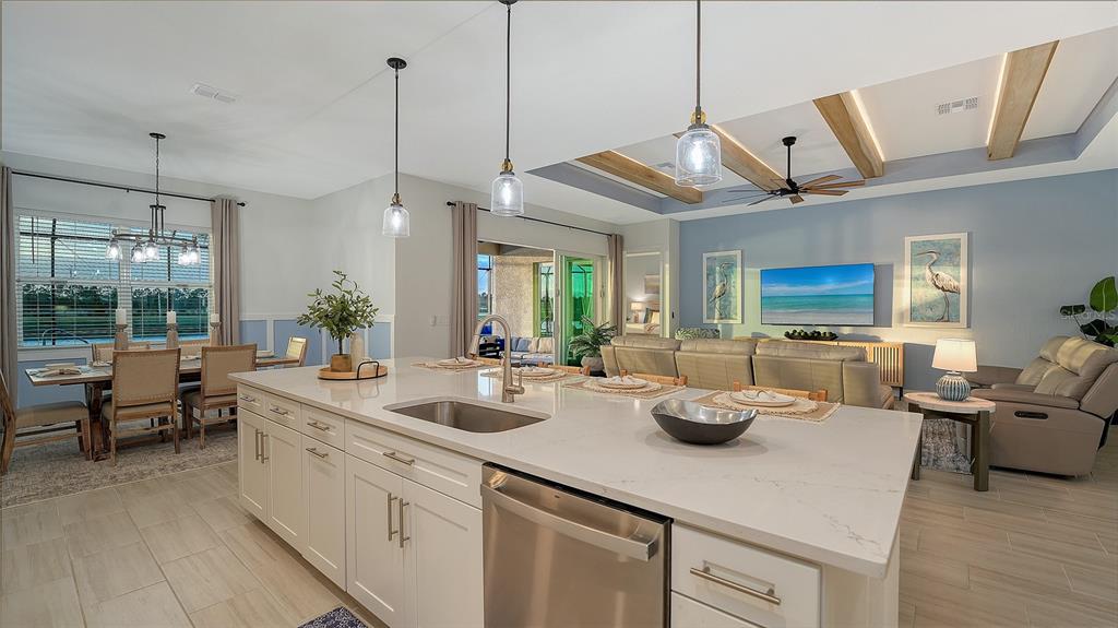 5612 Lightning Whelk Lane Lakewood Ranch, FL 34211 - Photo 24 of 44 a kitchen with sink and living room