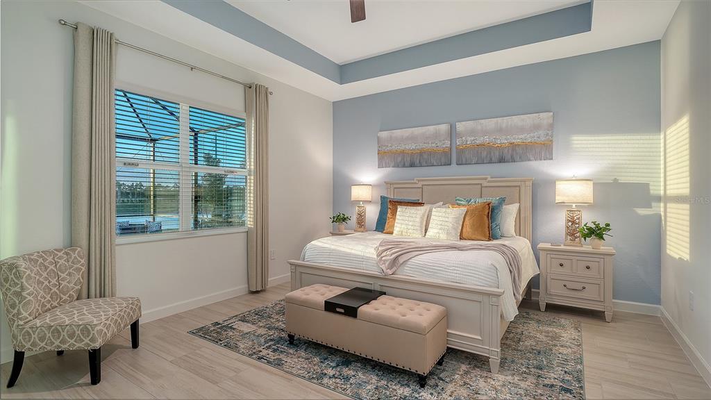 5612 Lightning Whelk Lane Lakewood Ranch, FL 34211 - Photo 25 of 44 a bedroom with a bed and a couch