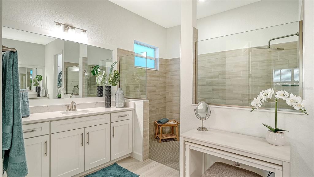 5612 Lightning Whelk Lane Lakewood Ranch, FL 34211 - Photo 28 of 44 a bathroom with a sink and a mirror