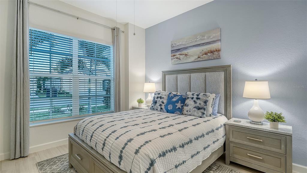 5612 Lightning Whelk Lane Lakewood Ranch, FL 34211 - Photo 32 of 44 a bedroom with a large bed and a window
