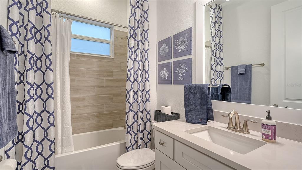 5612 Lightning Whelk Lane Lakewood Ranch, FL 34211 - Photo 34 of 44 a bathroom with a sink and a mirror