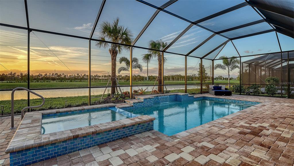 5612 Lightning Whelk Lane Lakewood Ranch, FL 34211 - Photo 40 of 44 a kitchen with a large window and a table