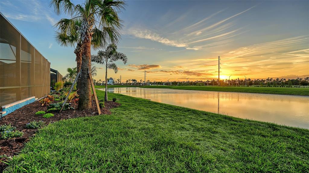 5612 Lightning Whelk Lane Lakewood Ranch, FL 34211 - Photo 41 of 44 a view of a lake with a yard