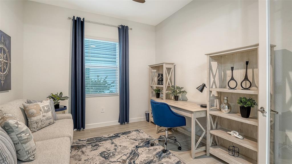 5612 Lightning Whelk Lane Lakewood Ranch, FL 34211 - Photo 8 of 44 a living room with furniture and wooden floor