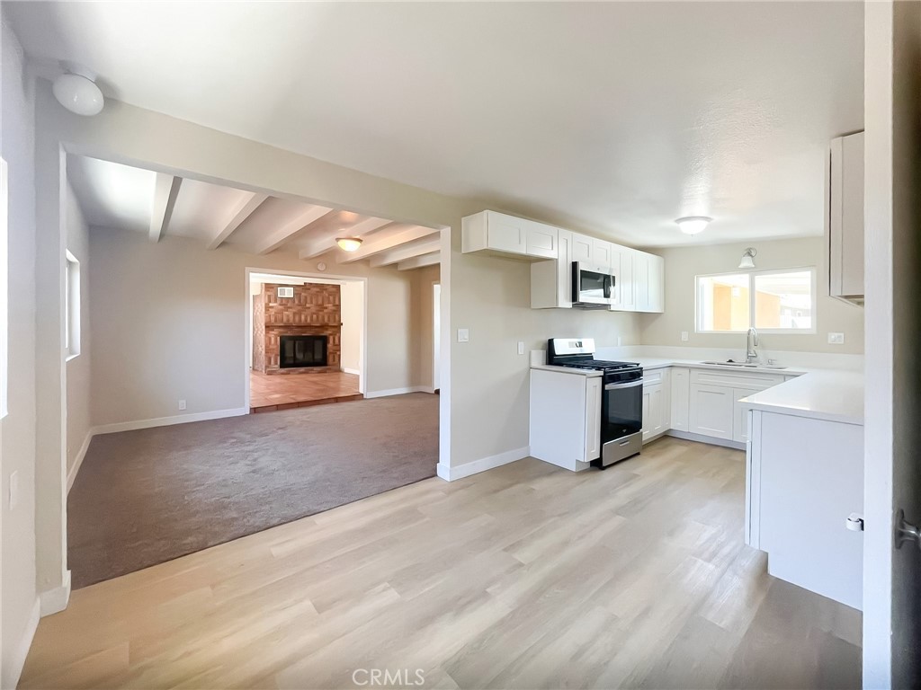 44739 3rd Street East Lancaster, CA 93535 - Photo 7 of 24 a large kitchen with kitchen island a sink stainless steel appliances and cabinets