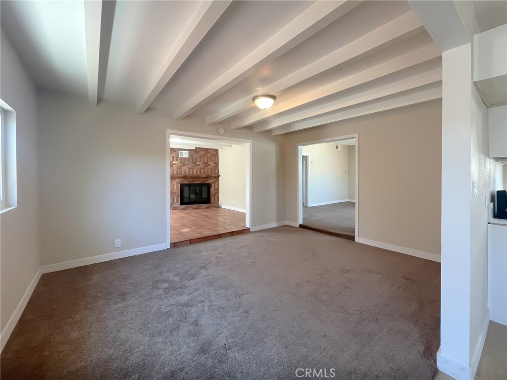 44739 3rd Street East Lancaster, CA 93535 - Photo 10 of 24 an empty room with windows and fireplace