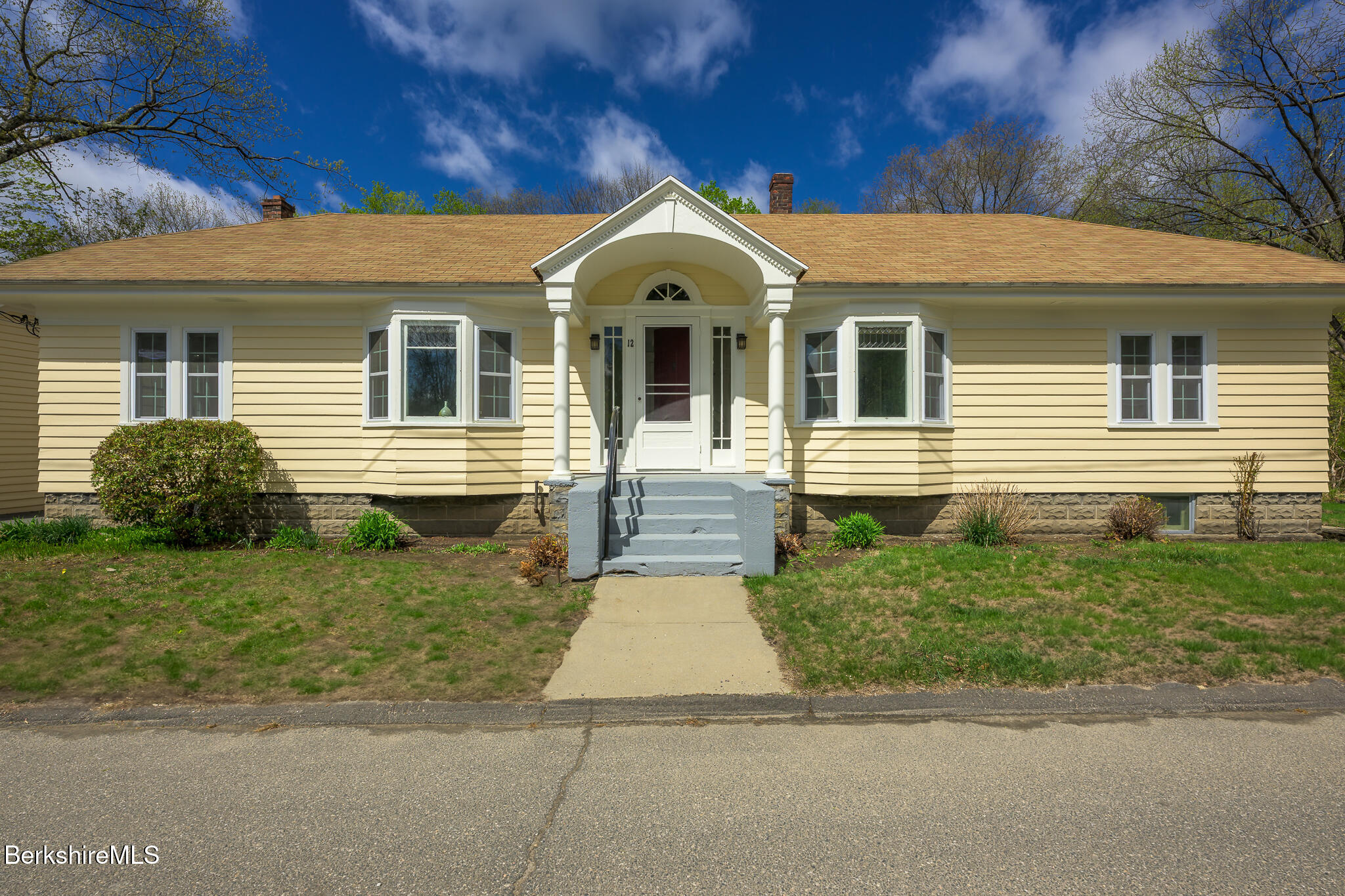 12 Riverfront Street Chester, MA 01011 - Photo 2 of 36 a front view of a house with a yard