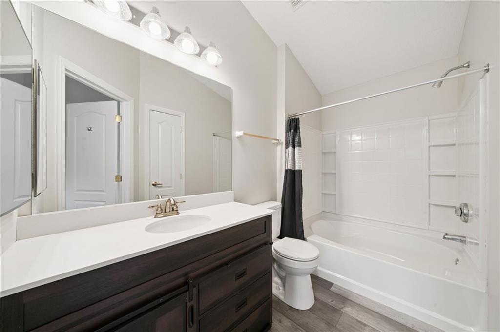 700 Hidden Ridge Court, Unit 302 South Park, PA 15129 - Photo 15 of 27 a bathroom with a bathtub shower sink mirror vanity and toilet