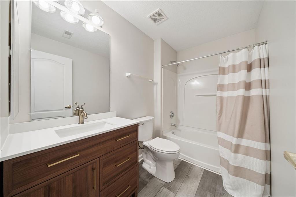 700 Hidden Ridge Court, Unit 302 South Park, PA 15129 - Photo 19 of 27 a bathroom with a sink a toilet a mirror and shower