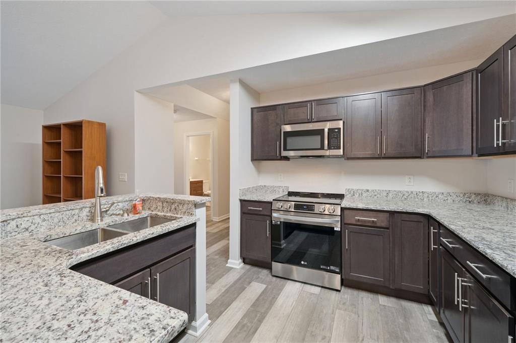 700 Hidden Ridge Court, Unit 302 South Park, PA 15129 - Photo 6 of 27 a kitchen with a sink stove and microwave