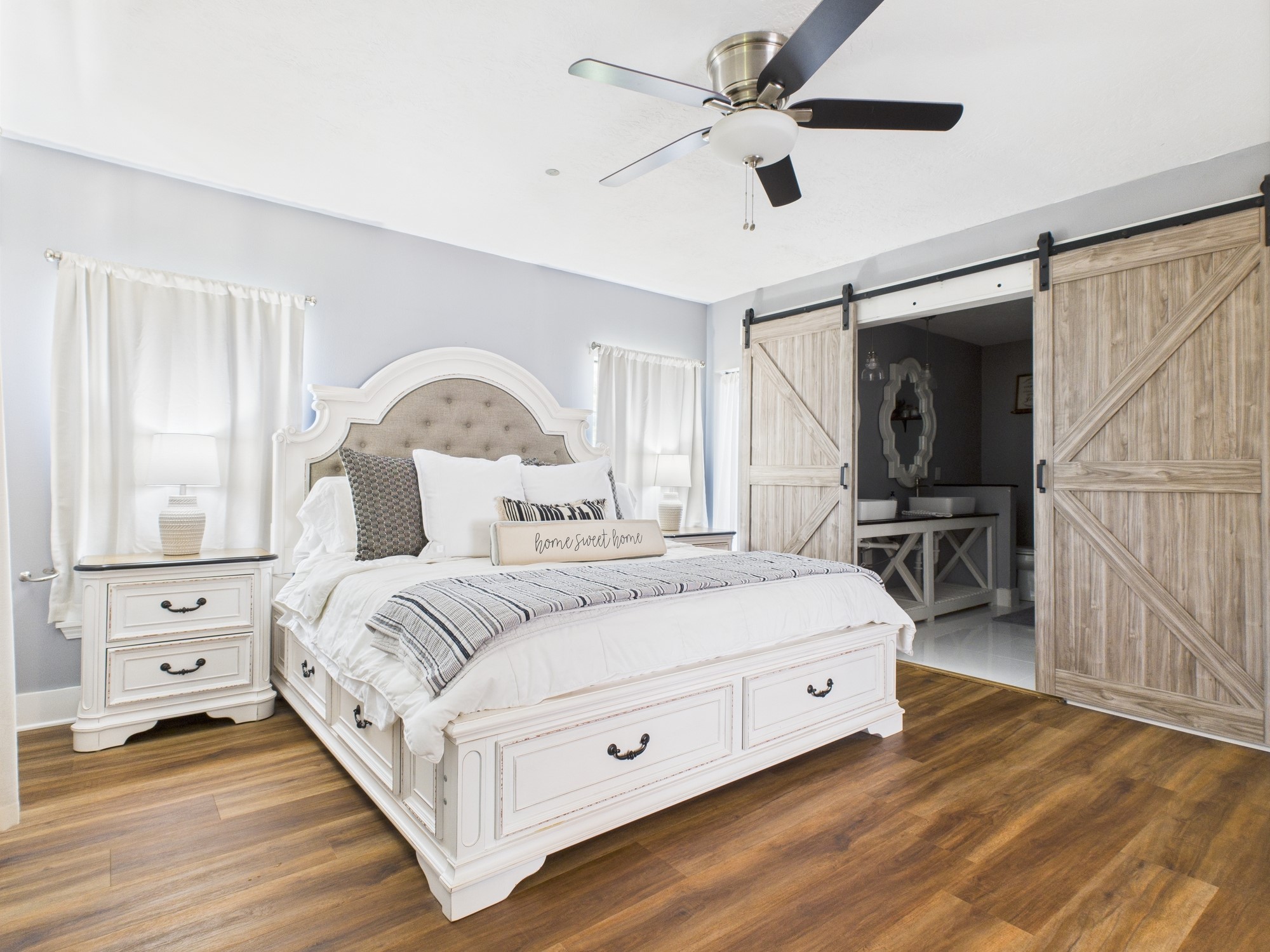 100 Hill Ranch Lane New Waverly, TX 77358 - Photo 20 of 23 a bedroom with a large bed and a chandelier