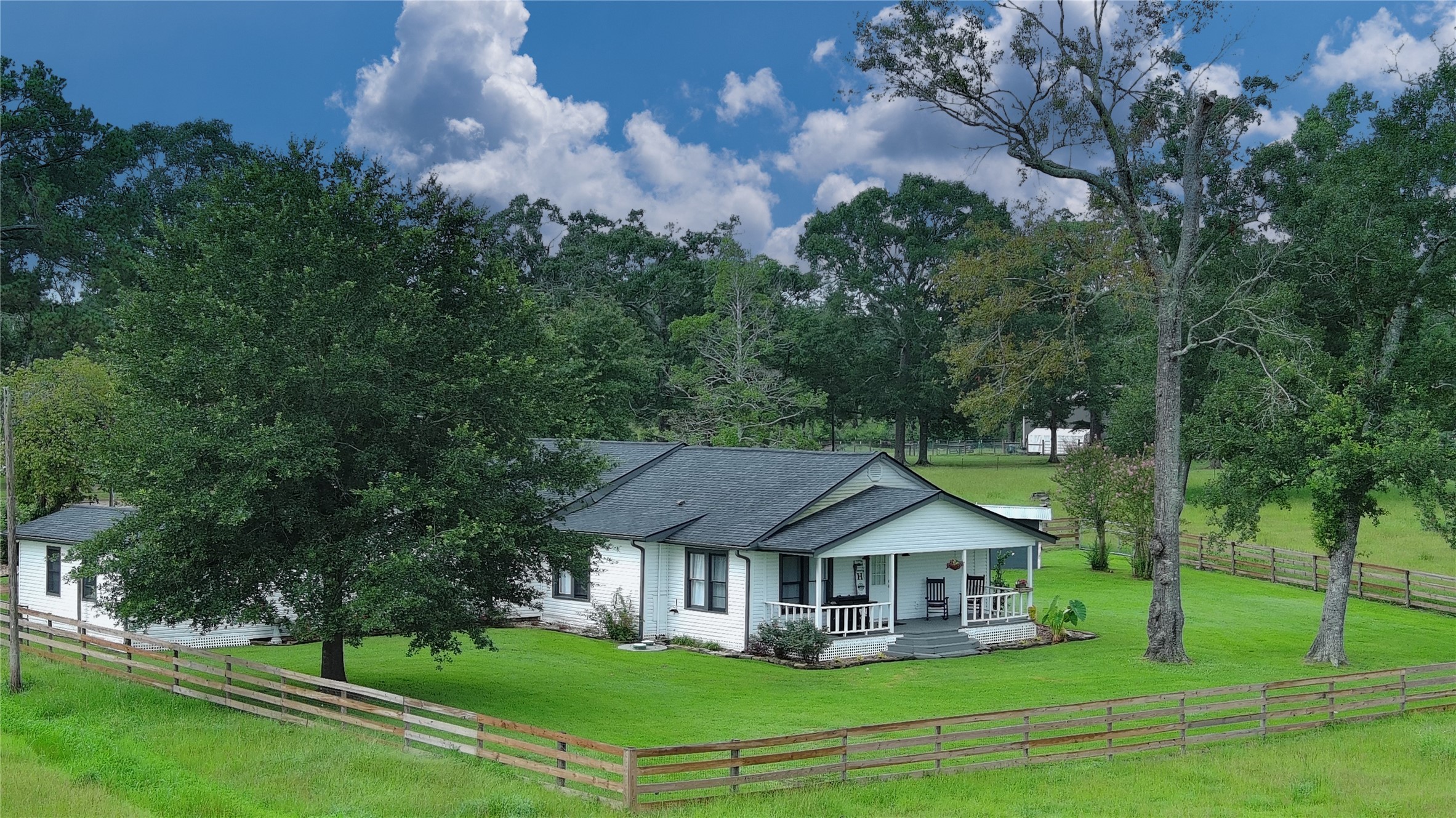 100 Hill Ranch Lane New Waverly, TX 77358 - Photo 2 of 23 a house that has lot of plants in it