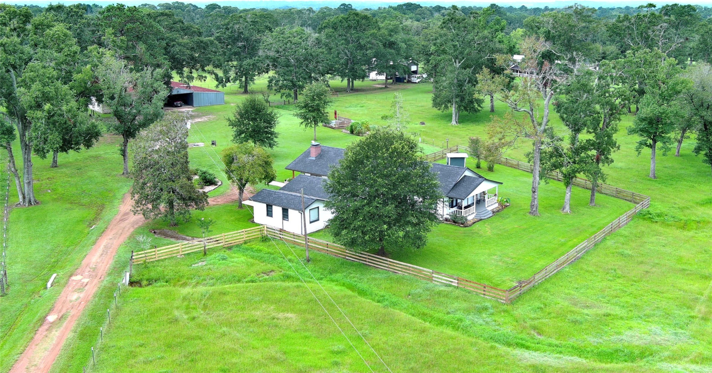 100 Hill Ranch Lane New Waverly, TX 77358 - Photo 3 of 23 a view of a garden with a building in the background