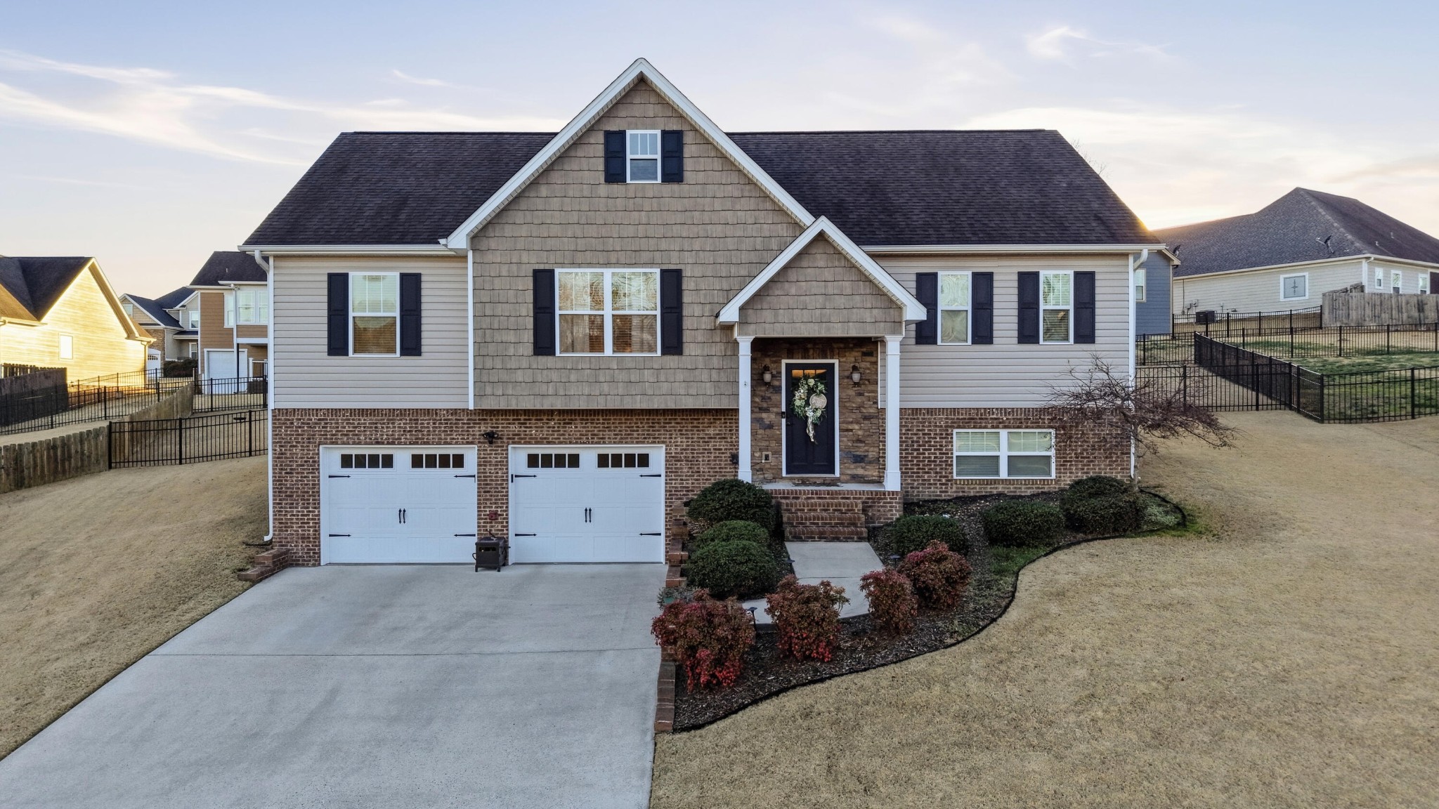 a front view of a house with a yard and garage