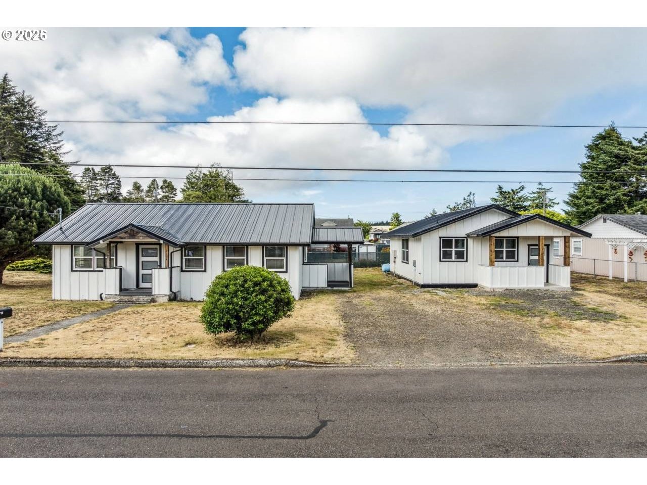 1184 2nd Street Florence, OR 97439 - Photo 1 of 44 a house view with a garden space