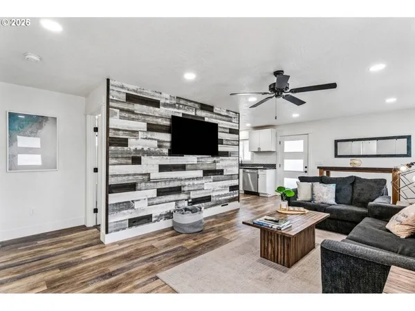 a kitchen with stainless steel appliances granite countertop a stove top oven a refrigerator and a sink