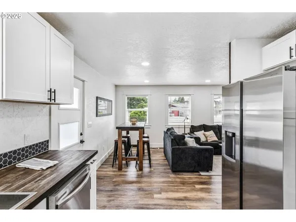 a view of kitchen with granite countertop cabinets
