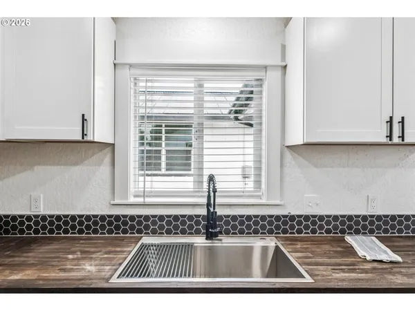 a kitchen with stainless steel appliances kitchen island granite countertop a stove and a sink