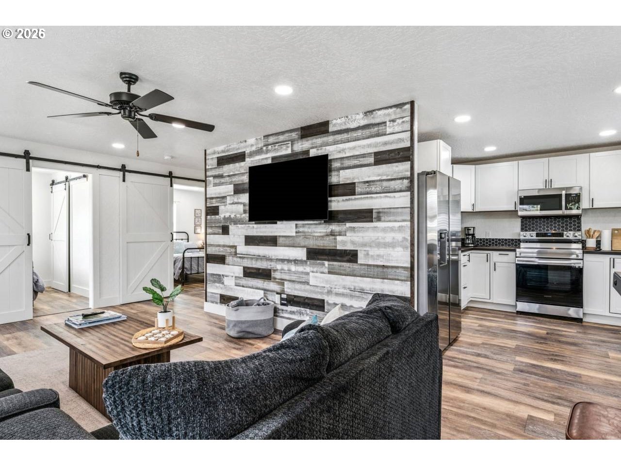 1184 2nd Street Florence, OR 97439 - Photo 20 of 44 a living room with stainless steel appliances kitchen island a table and chairs in it