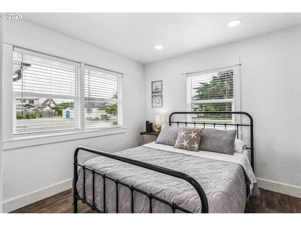 a bedroom with a bed and a painting on the wall
