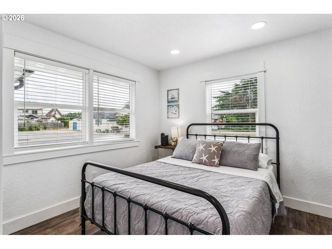 1184 2nd Street Florence, OR 97439 - Photo 21 of 44 a bedroom with a large bed and a window