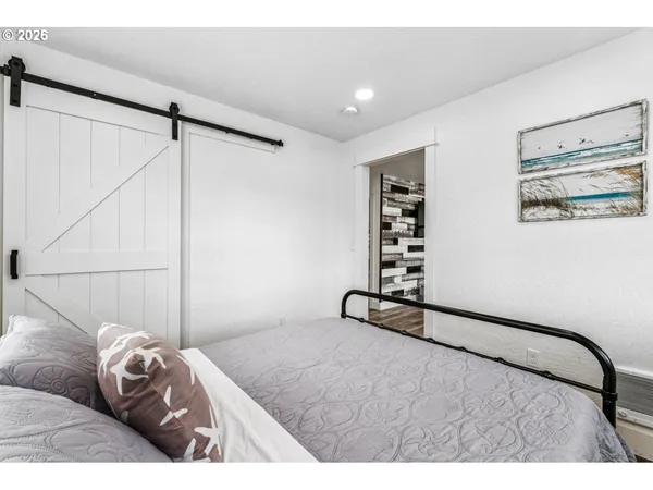 a bedroom with a large bed and a window