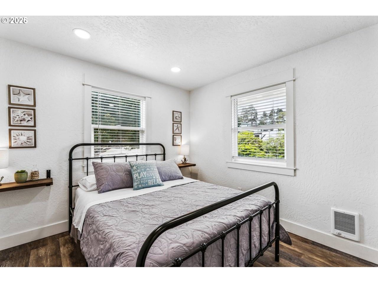 1184 2nd Street Florence, OR 97439 - Photo 23 of 44 a bedroom with a large bed and a window