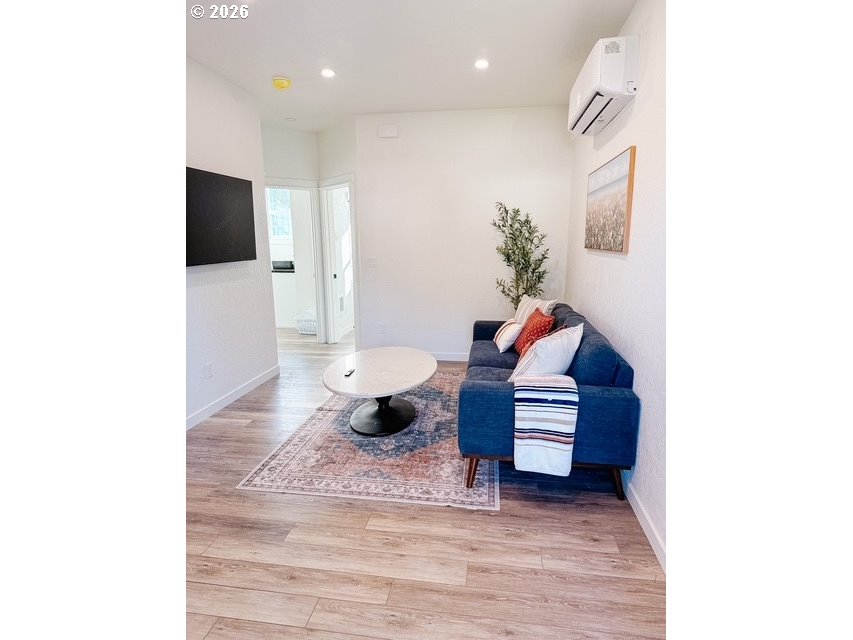 1184 2nd Street Florence, OR 97439 - Photo 36 of 44 a living room with furniture and a flat screen tv