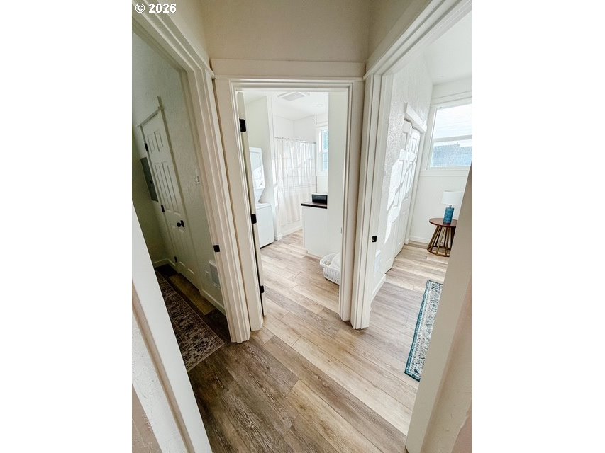 1184 2nd Street Florence, OR 97439 - Photo 37 of 44 a view of a hallway with wooden floor and staircase