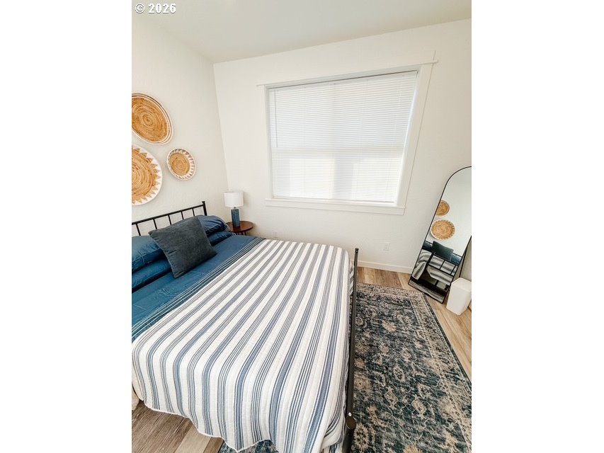 1184 2nd Street Florence, OR 97439 - Photo 39 of 44 a bedroom with a bed and a window