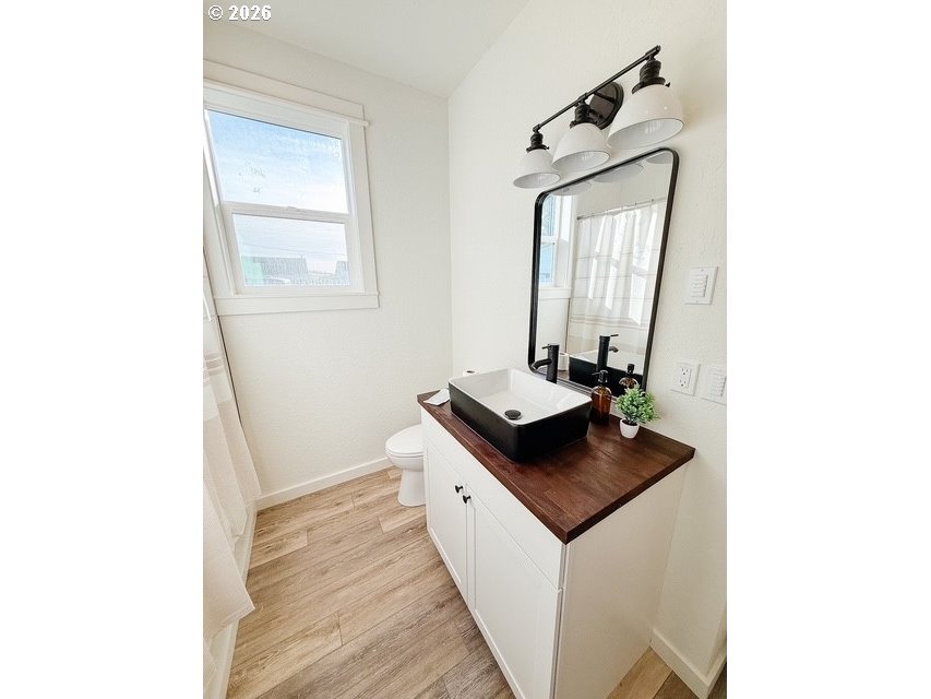 1184 2nd Street Florence, OR 97439 - Photo 41 of 44 a bathroom with a sink and a mirror