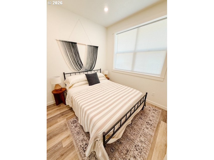 1184 2nd Street Florence, OR 97439 - Photo 44 of 44 a bedroom with a bed and a window