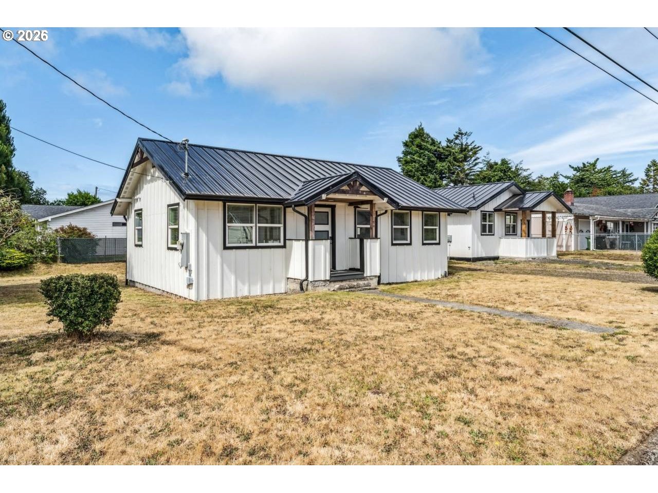 1184 2nd Street Florence, OR 97439 - Photo 7 of 44 a house with trees in the background