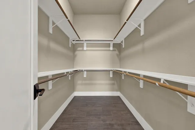 a view of a room with wooden floor