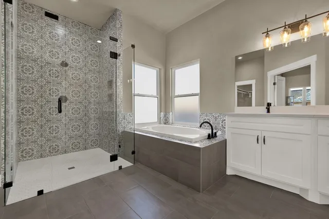 a bathroom with a tub sink and mirror