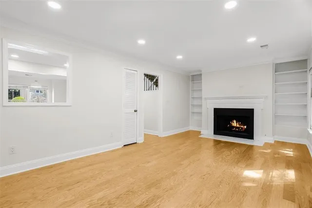 a view of an empty room with a fireplace