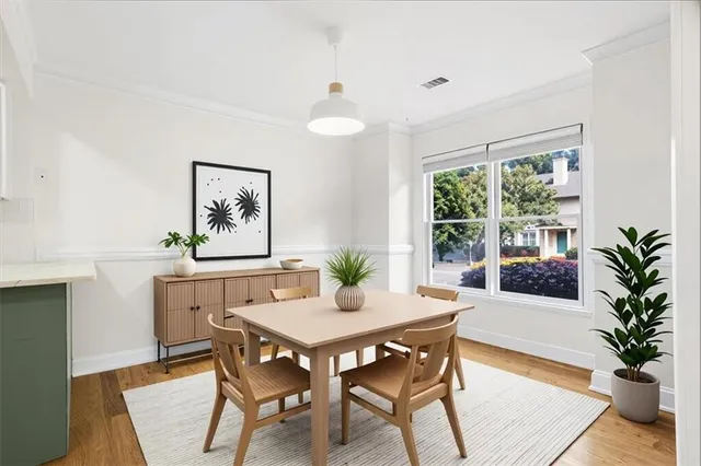 a view of a dining room with furniture window and wooden floor