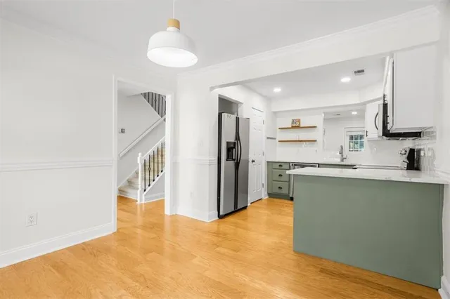 a kitchen with stainless steel appliances granite countertop a refrigerator and a sink
