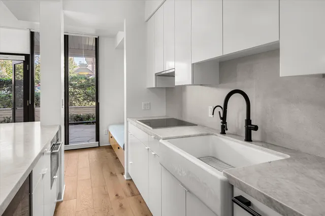 a kitchen with stainless steel appliances granite countertop a sink a stove a refrigerator and cabinets