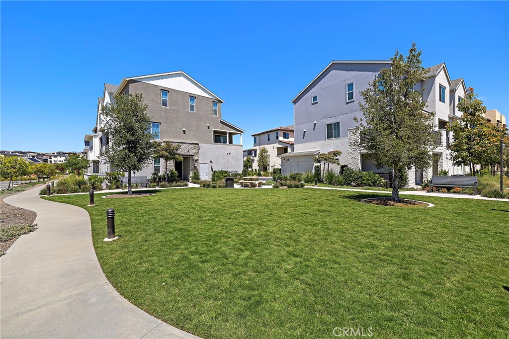 61 Wheelbarrow Road Rancho Mission Viejo, CA 92694 - Photo 46 of 74 a view of a big yard with a building in the background