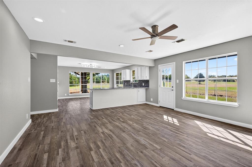 5023 West Line Road Whitesboro, TX 76273 - Photo 26 of 40 a view of a kitchen with a sink and dishwasher with wooden floor