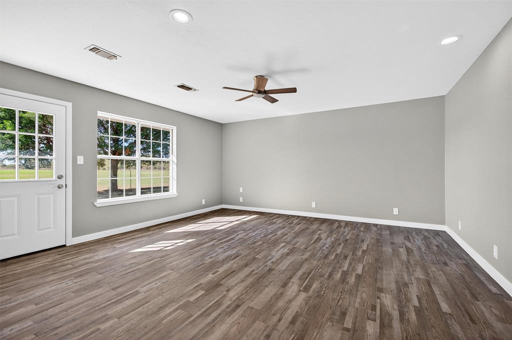 5023 West Line Road Whitesboro, TX 76273 - Photo 27 of 40 wooden floor in an empty room with a window