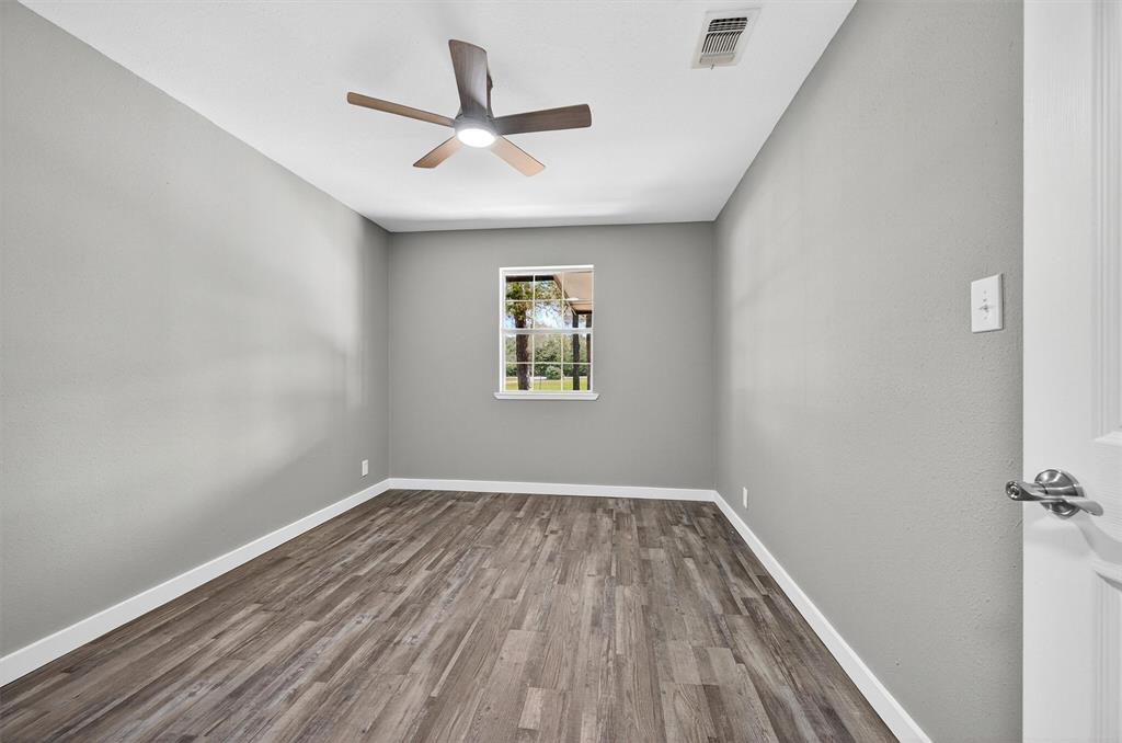 5023 West Line Road Whitesboro, TX 76273 - Photo 30 of 40 an empty room with a window and a ceiling fan