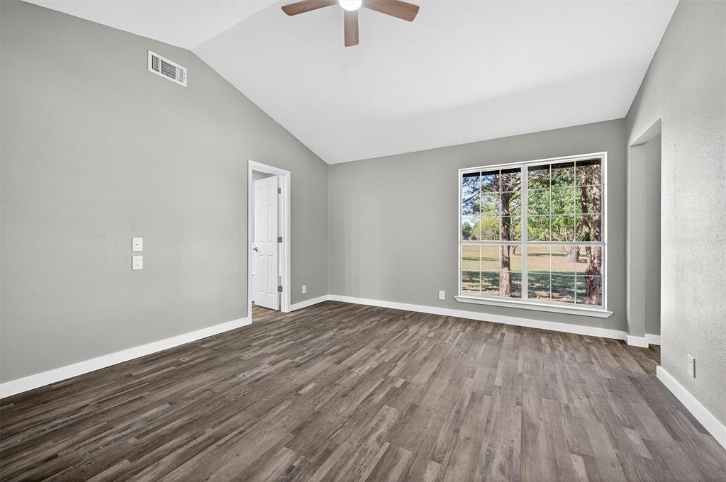 5023 West Line Road Whitesboro, TX 76273 - Photo 32 of 40 a view of an empty room with wooden floor and a window