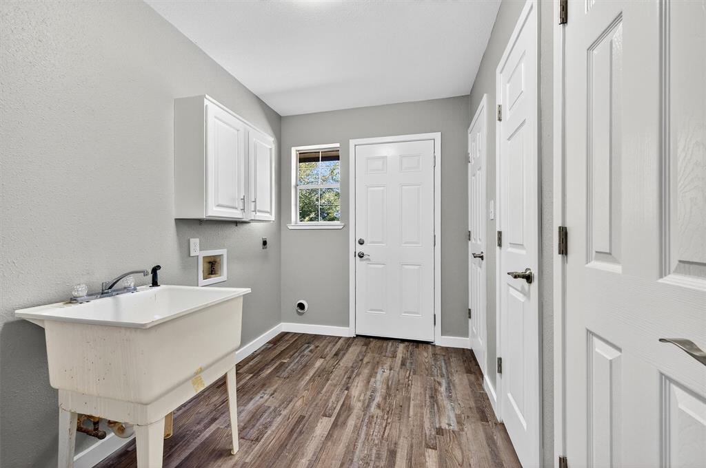 5023 West Line Road Whitesboro, TX 76273 - Photo 37 of 40 a view of a kitchen cabinets a sink and wooden floor